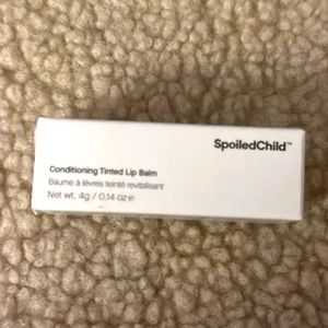 Spoiled child conditioning lip balm in natural pink.